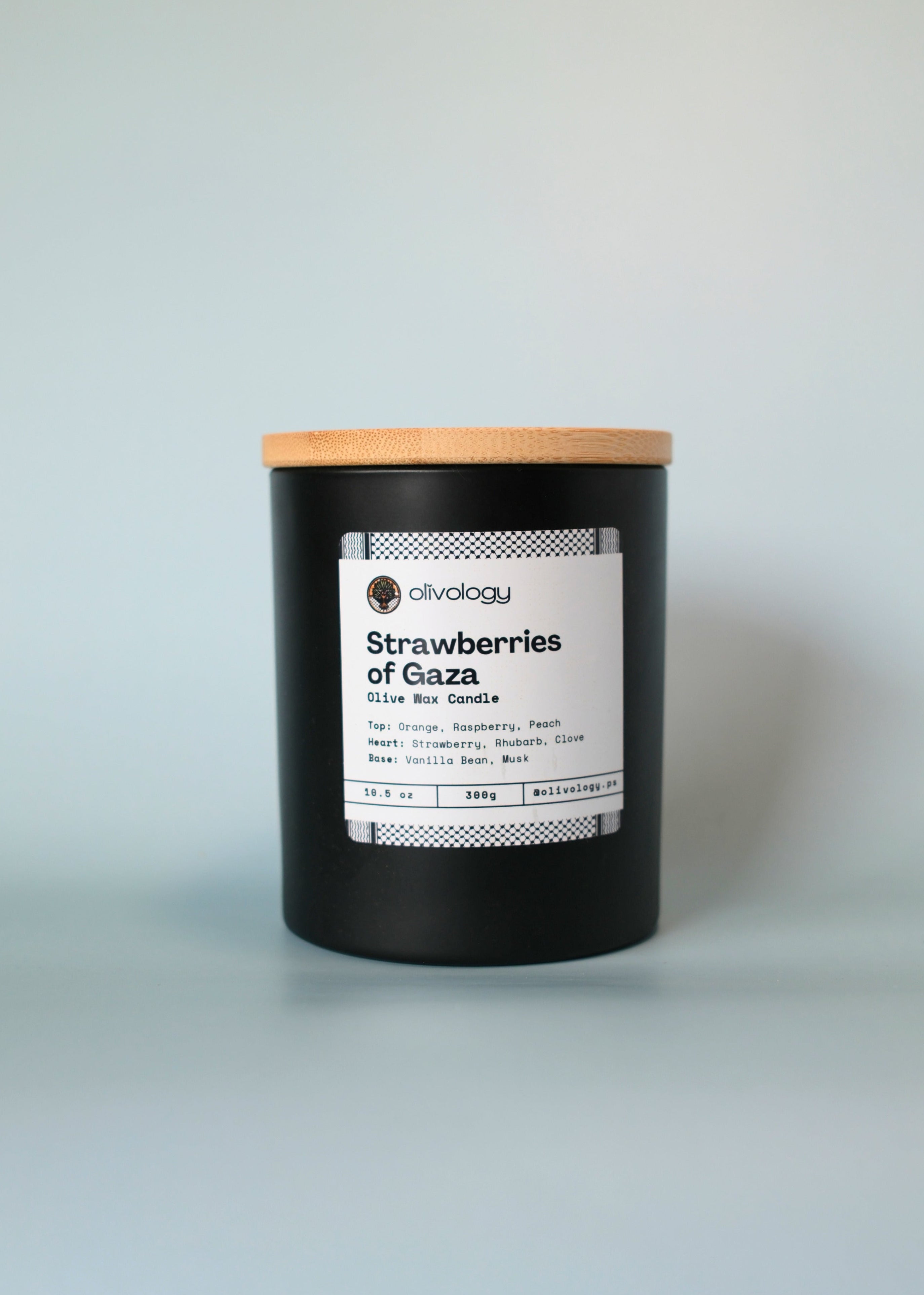 Candle with a wooden lid on a light gray background