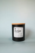 Candle with a wooden lid labeled 'Spice Market of Jerusalem' on a white background